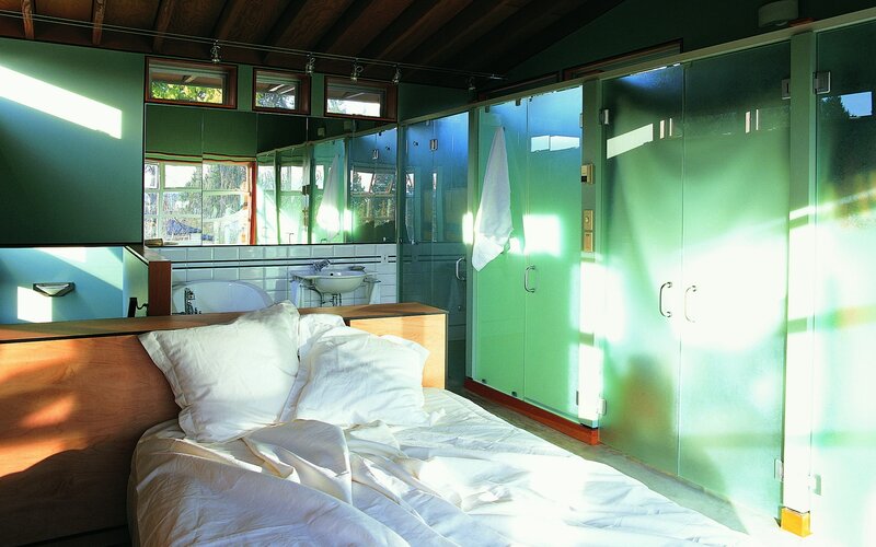 Modern bedroom with green glass walls
