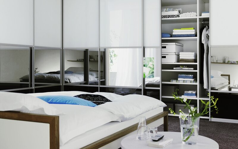 Modern bedroom with mirrored wardrobe