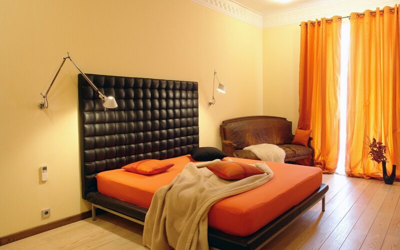 Modern bedroom with orange accents