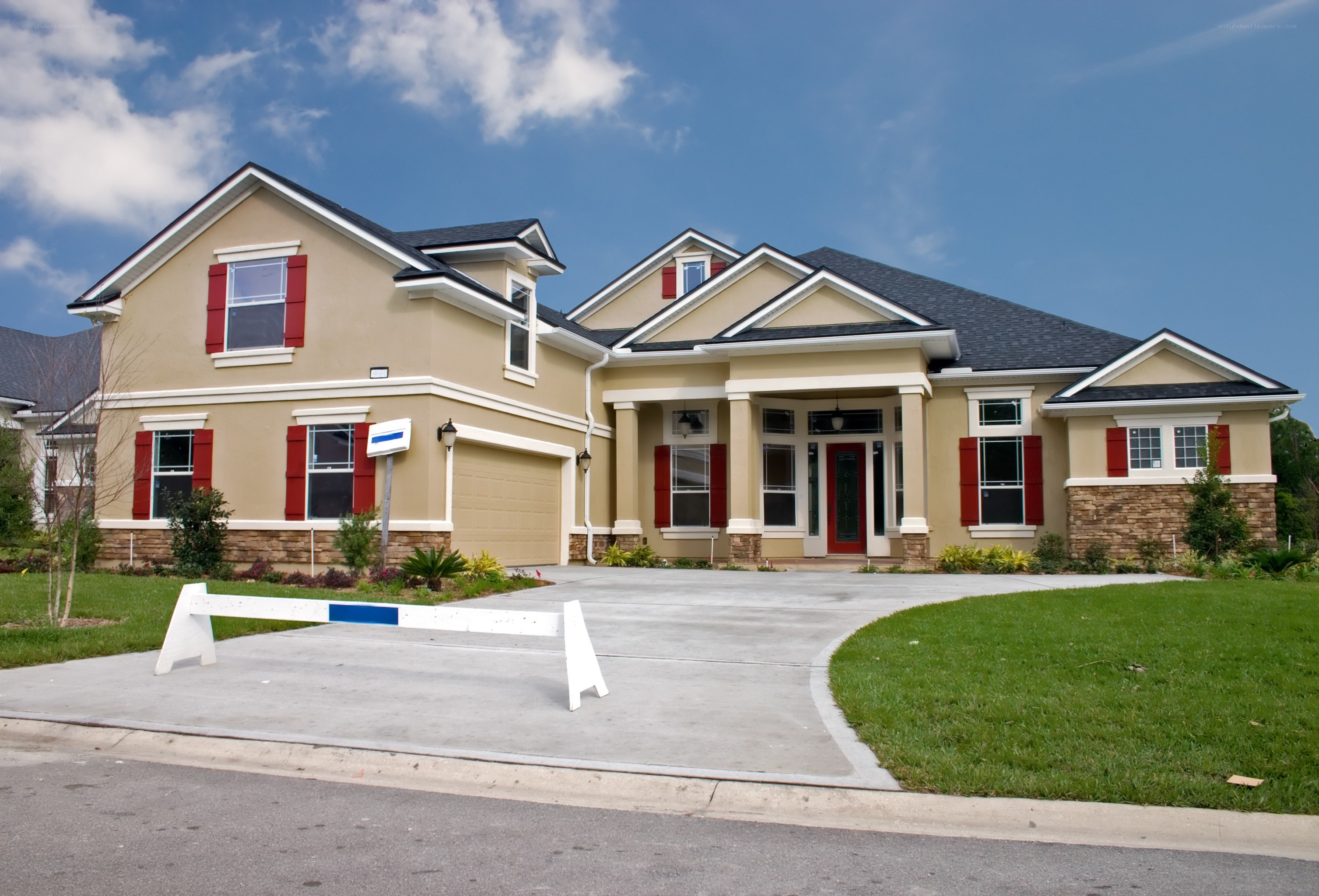modern beige house with red shutters
