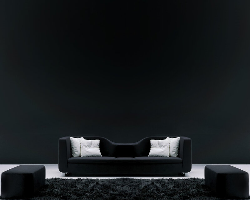 Modern black sofa with white pillows