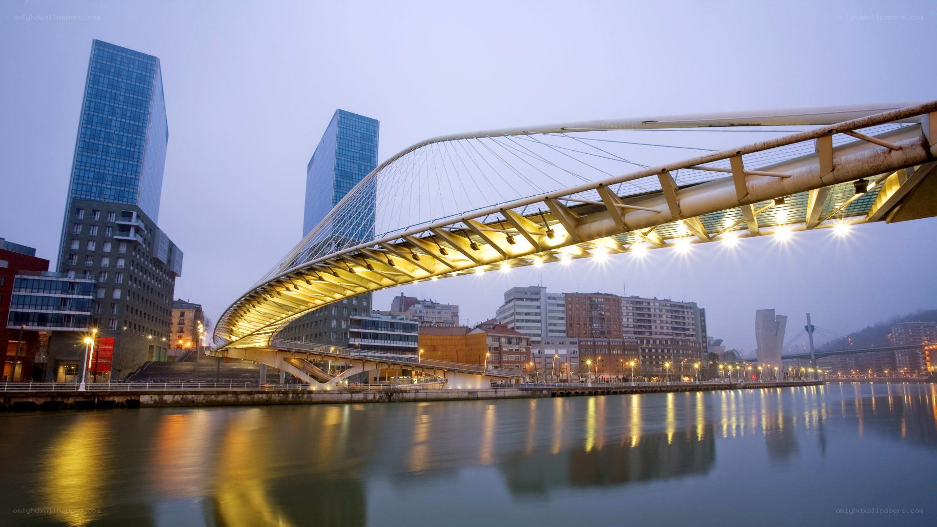 Modern bridge over river at dusk