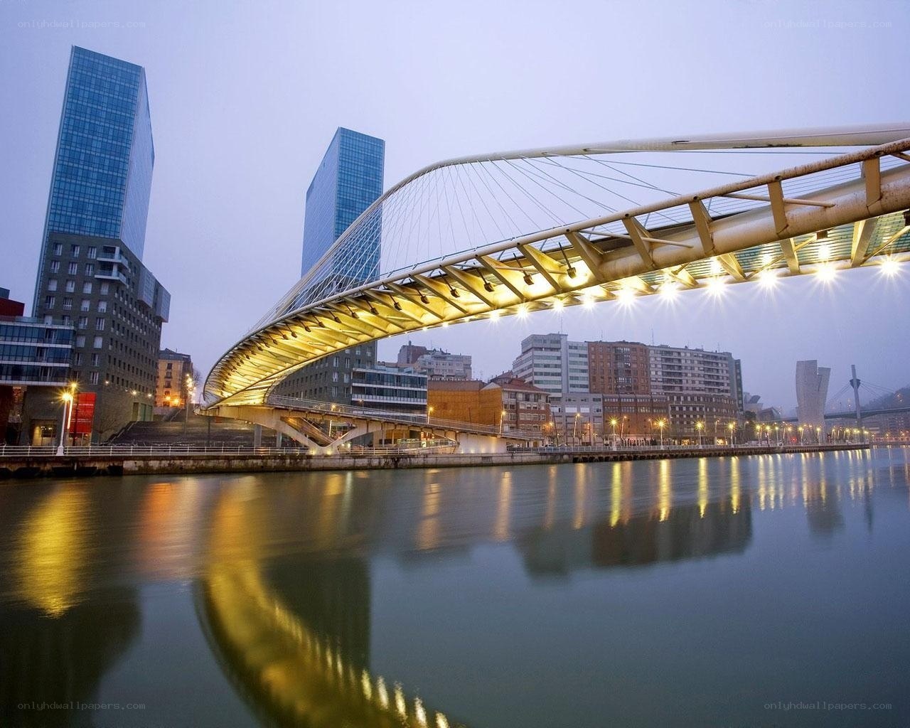 Modern bridge over river at dusk