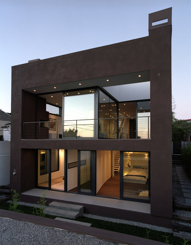 modern brown house with glass walls