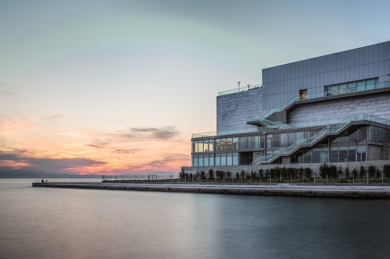 Modern Building by Water — Blue, Serene, Sunset