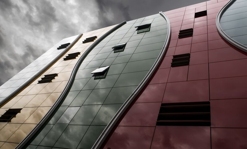 Modern Building Facade — Gray, Dramatic, Photograph, Clouds
