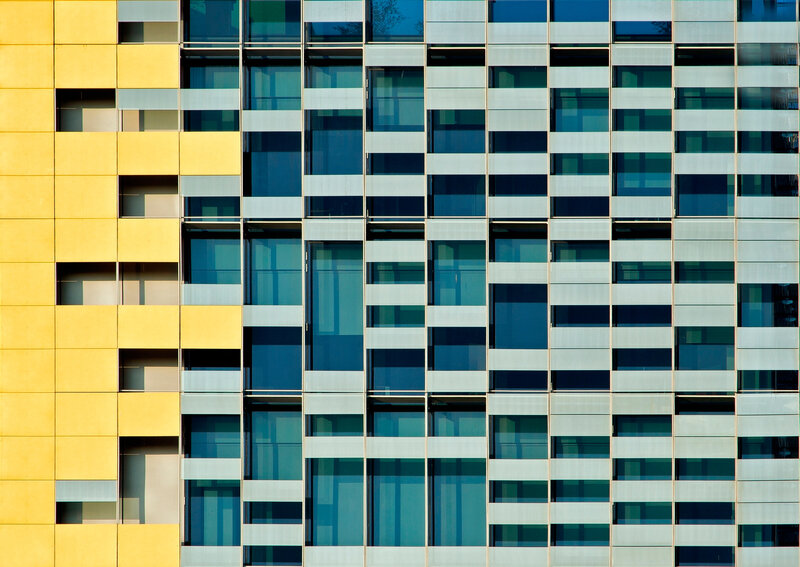 Modern building facade with yellow and glass panels