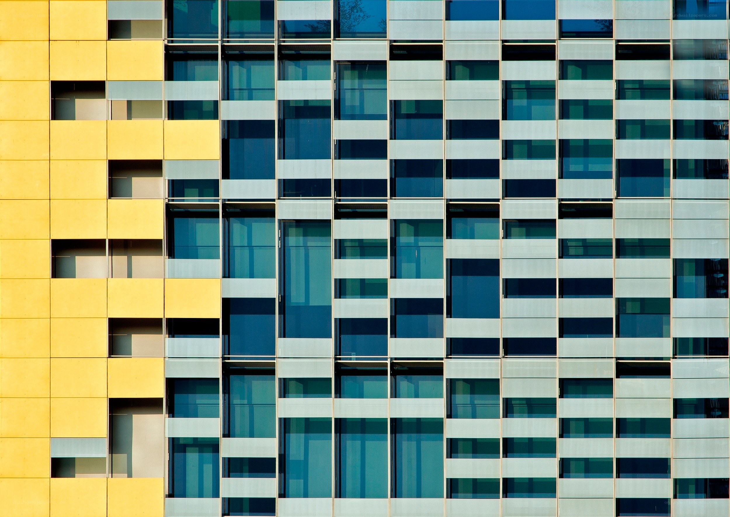 Modern building facade with yellow and glass panels