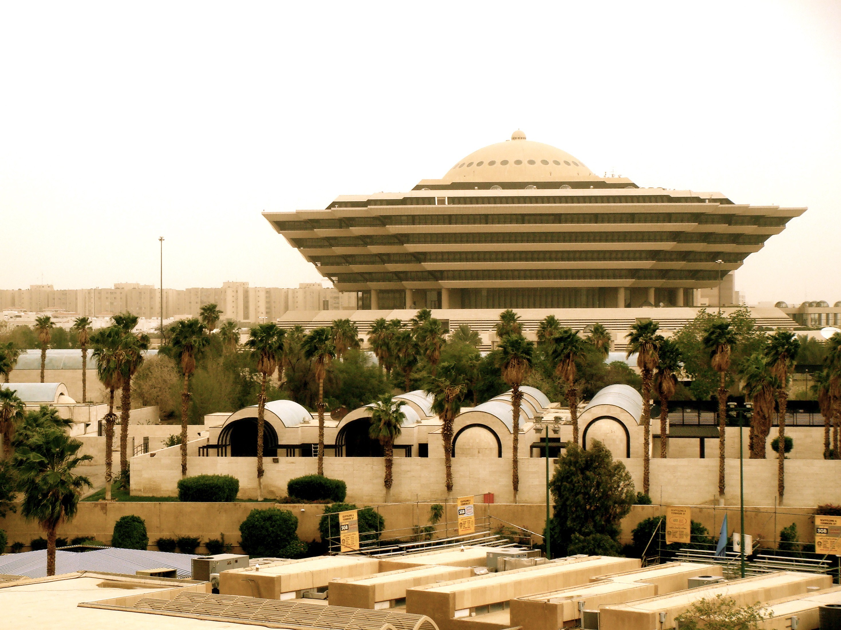Modern building with dome and palm trees
