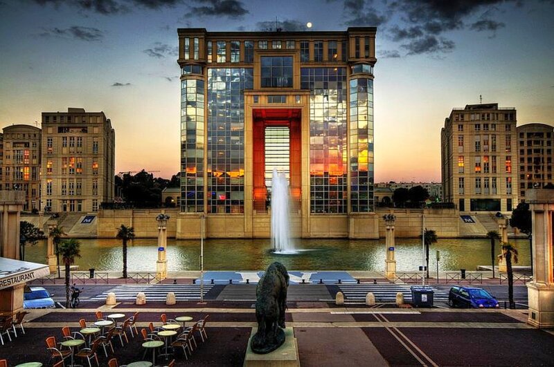 Modern building with fountain at dusk