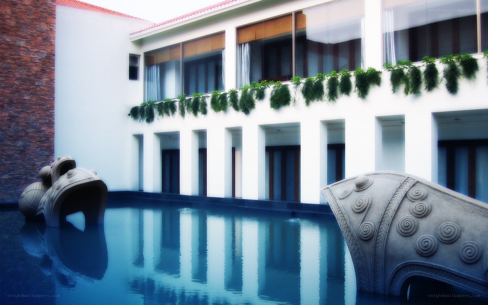 Modern building with pool and sculptures