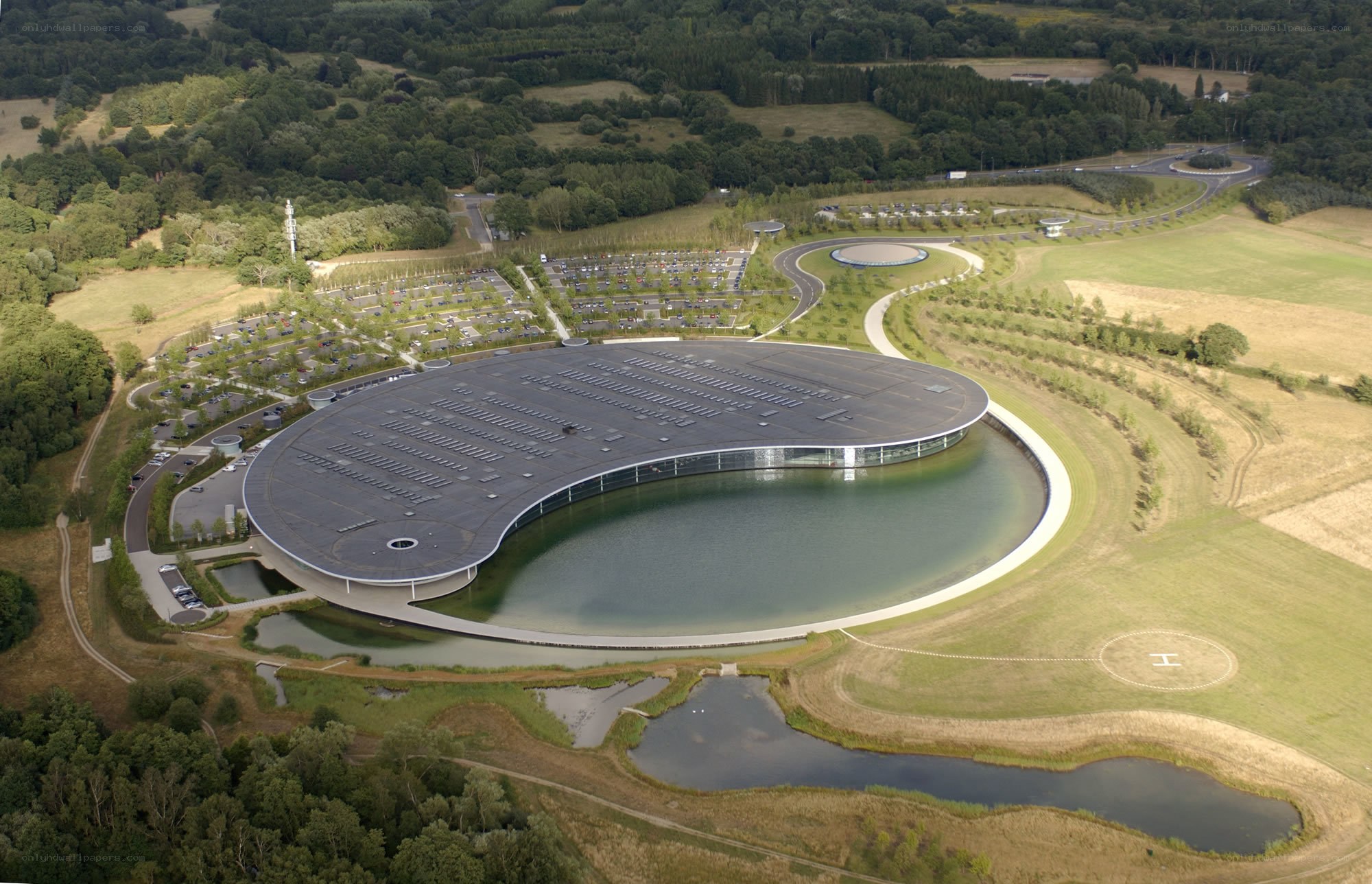 modern circular building with lake