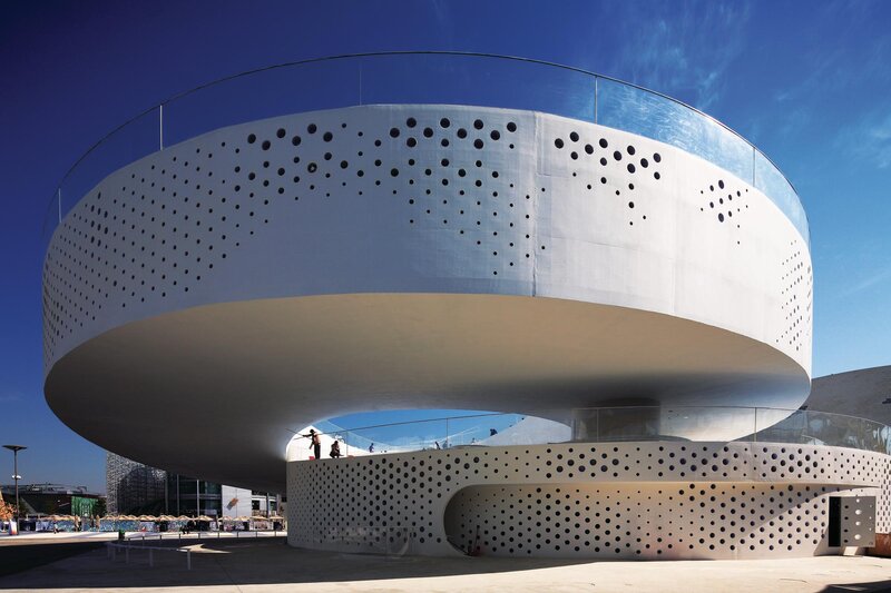 modern circular building with perforated facade