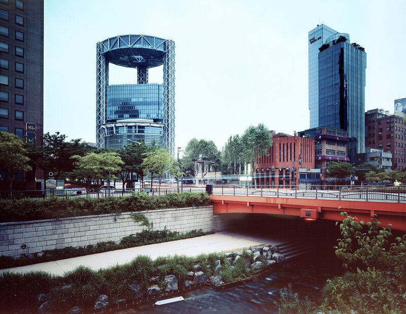 Modern cityscape with river and bridge