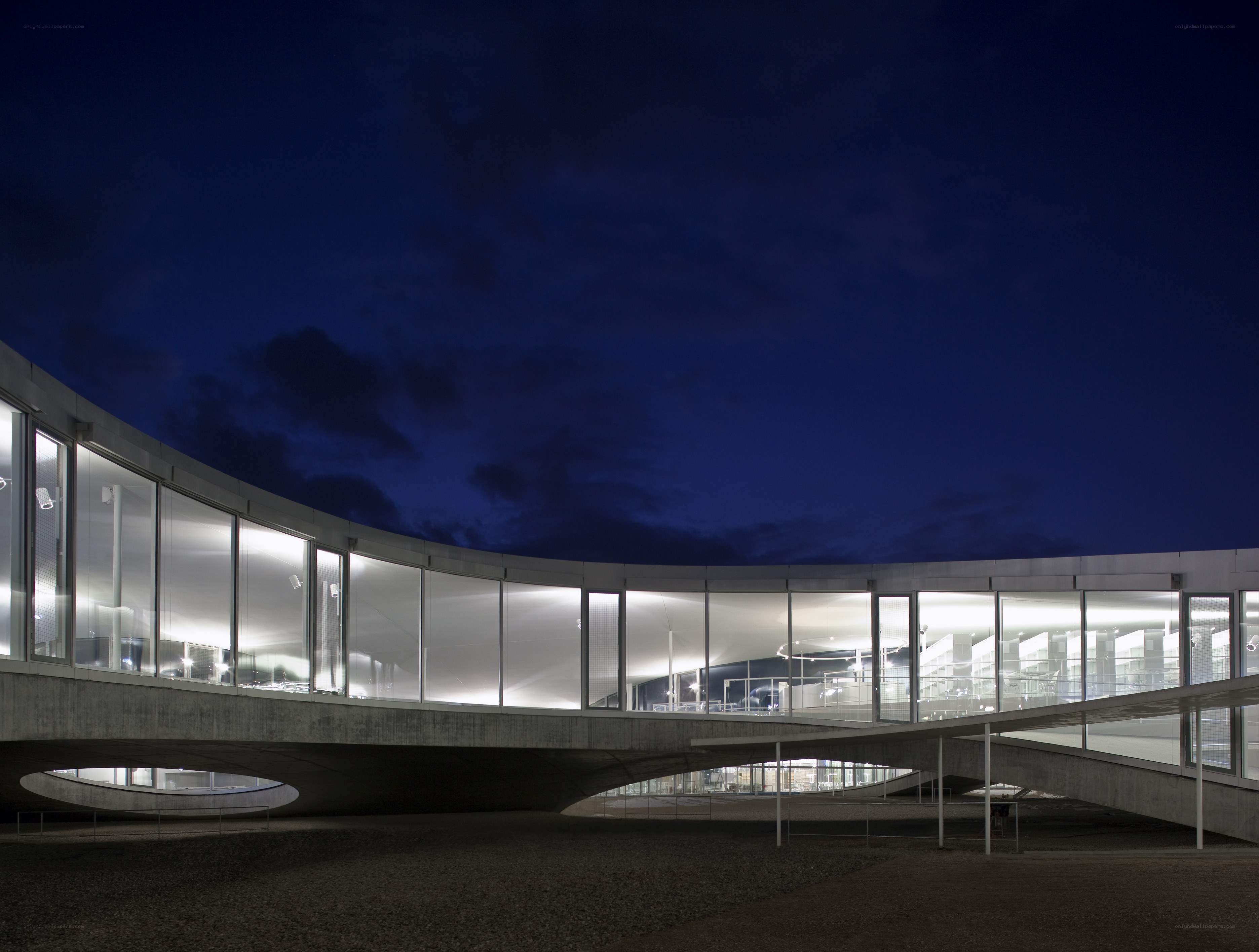 Modern curved building at night
