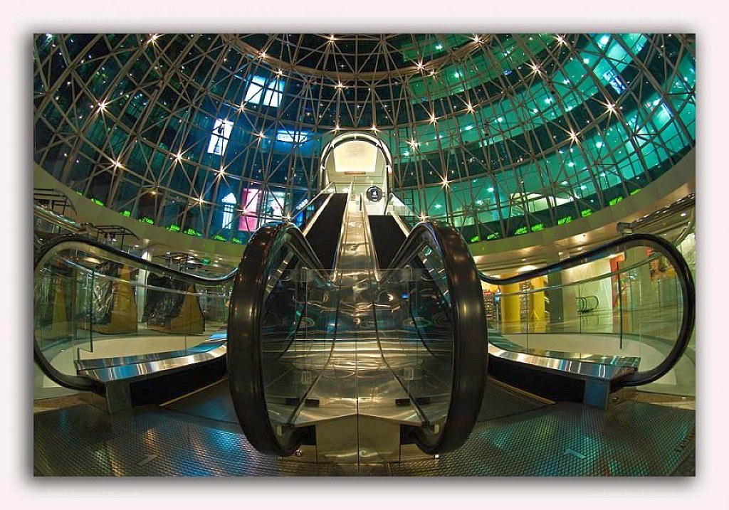 Modern escalator in glass dome