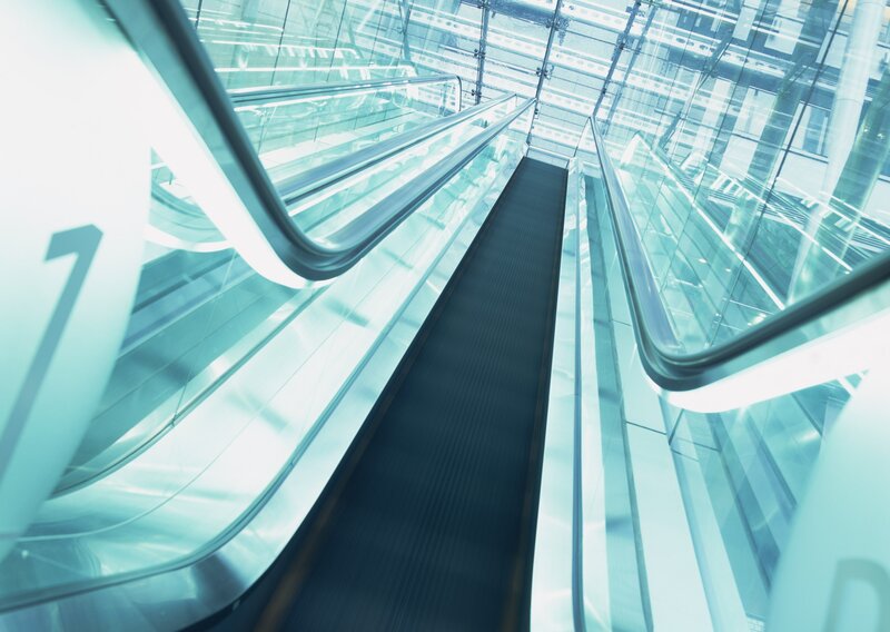 Modern escalator in glass structure