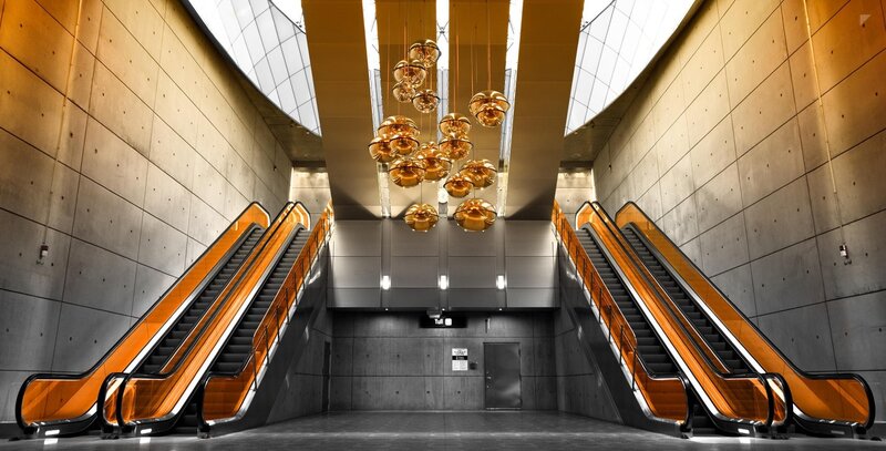 Modern Escalator Station — Orange