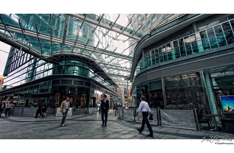 Modern glass atrium with pedestrians