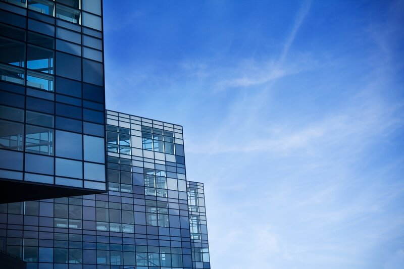modern glass building against blue sky