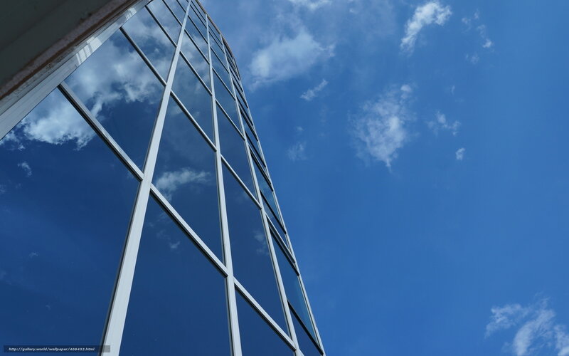 Modern glass building against blue sky