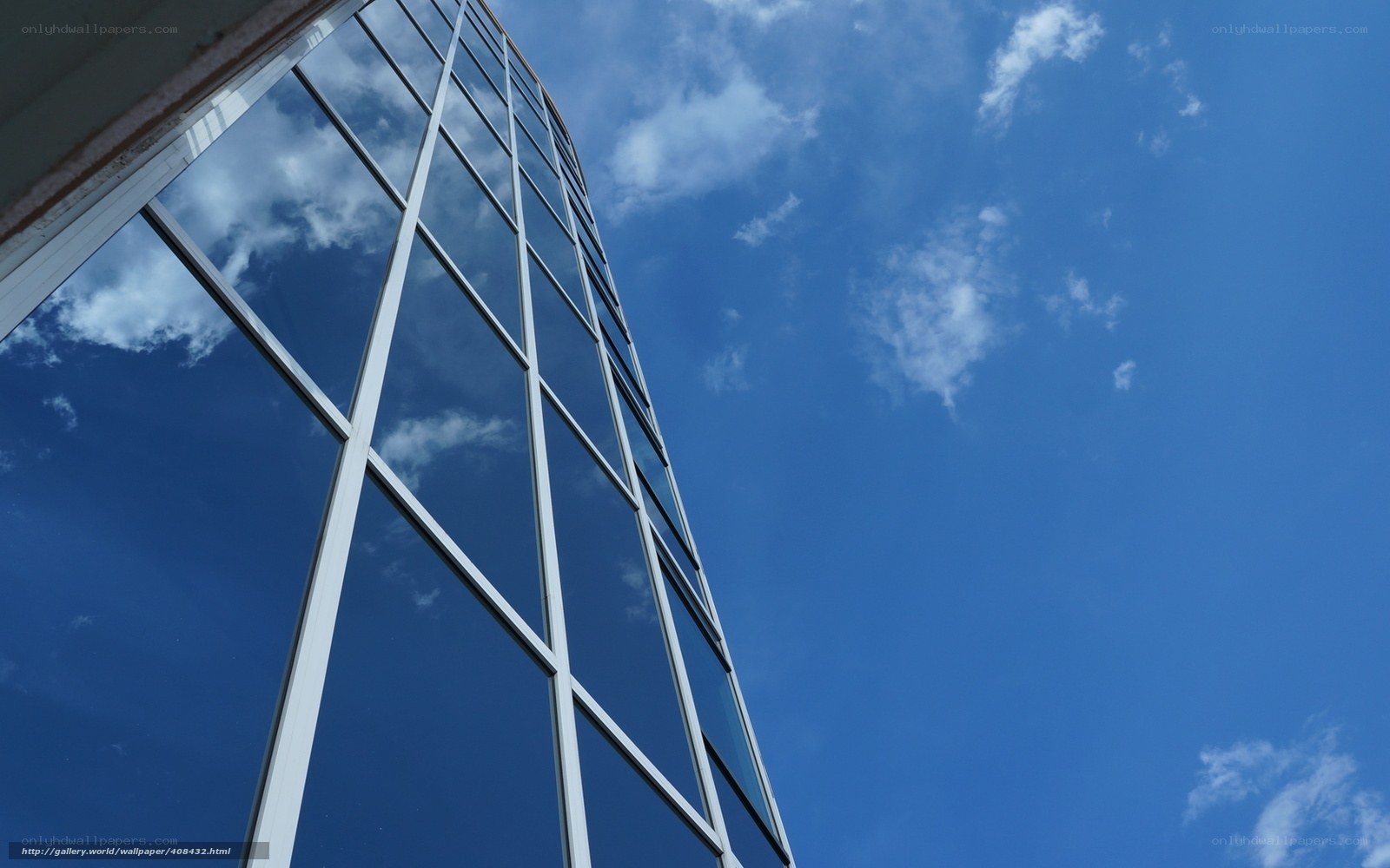 Modern glass building against blue sky