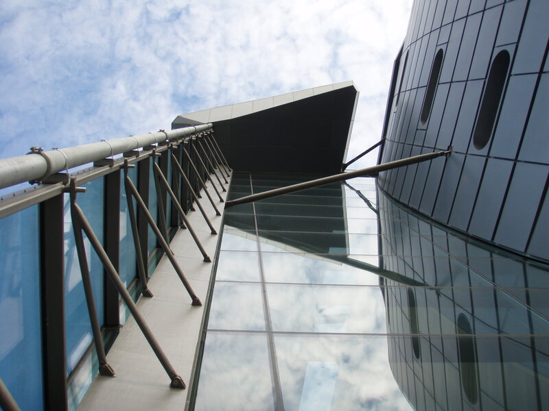 Modern Glass Building — Blue, Dramatic, Afternoon, Photograph, Glass Facade, Metal Railing