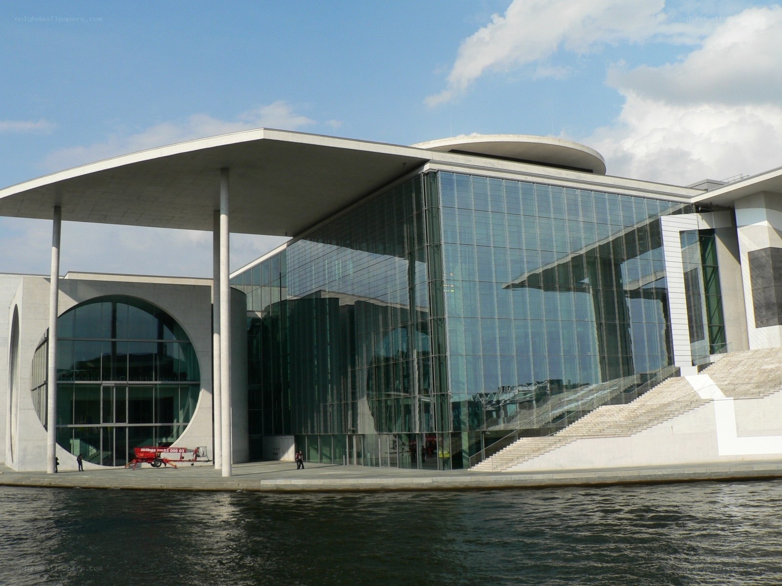 modern glass building by water