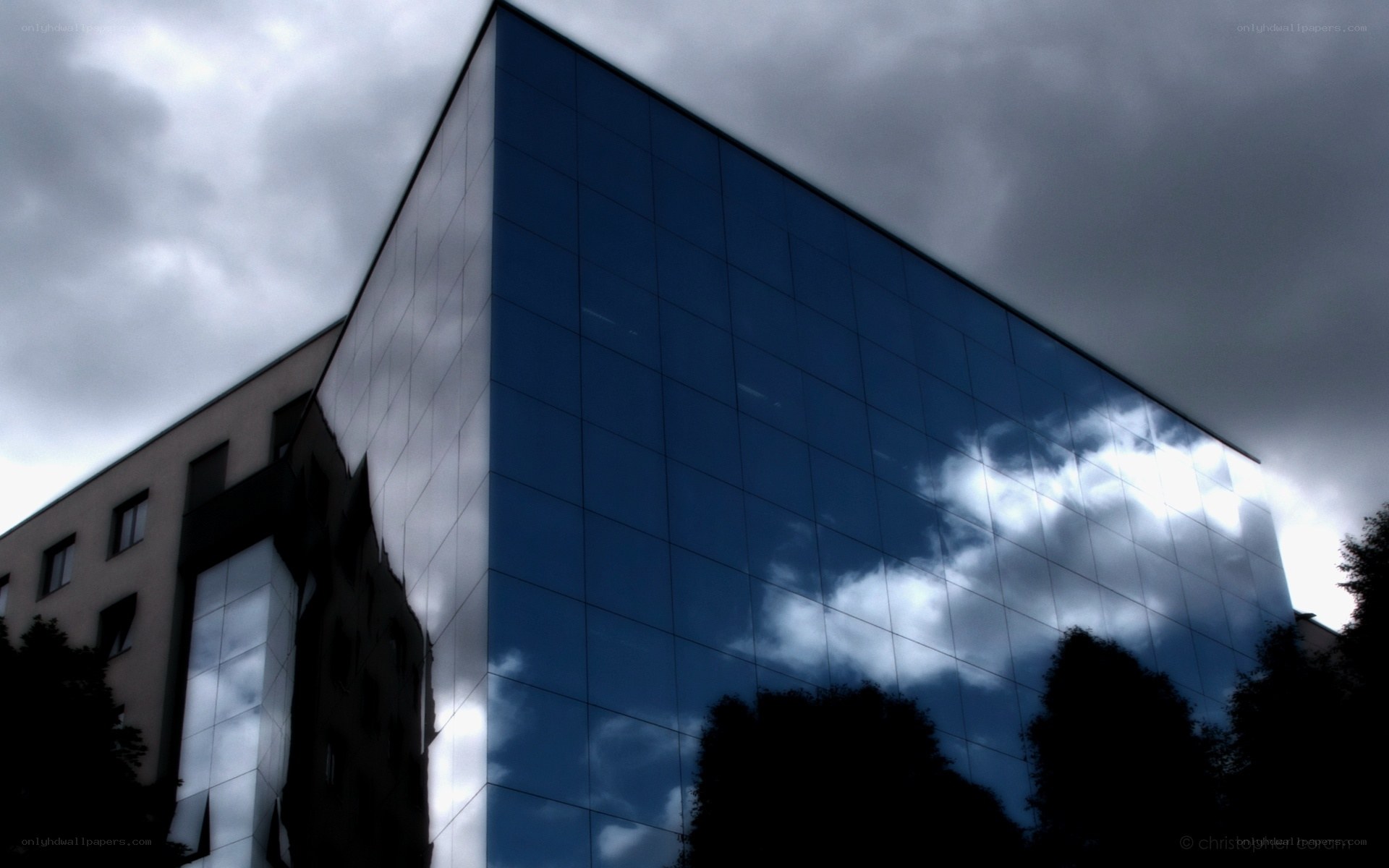 modern glass building under cloudy sky