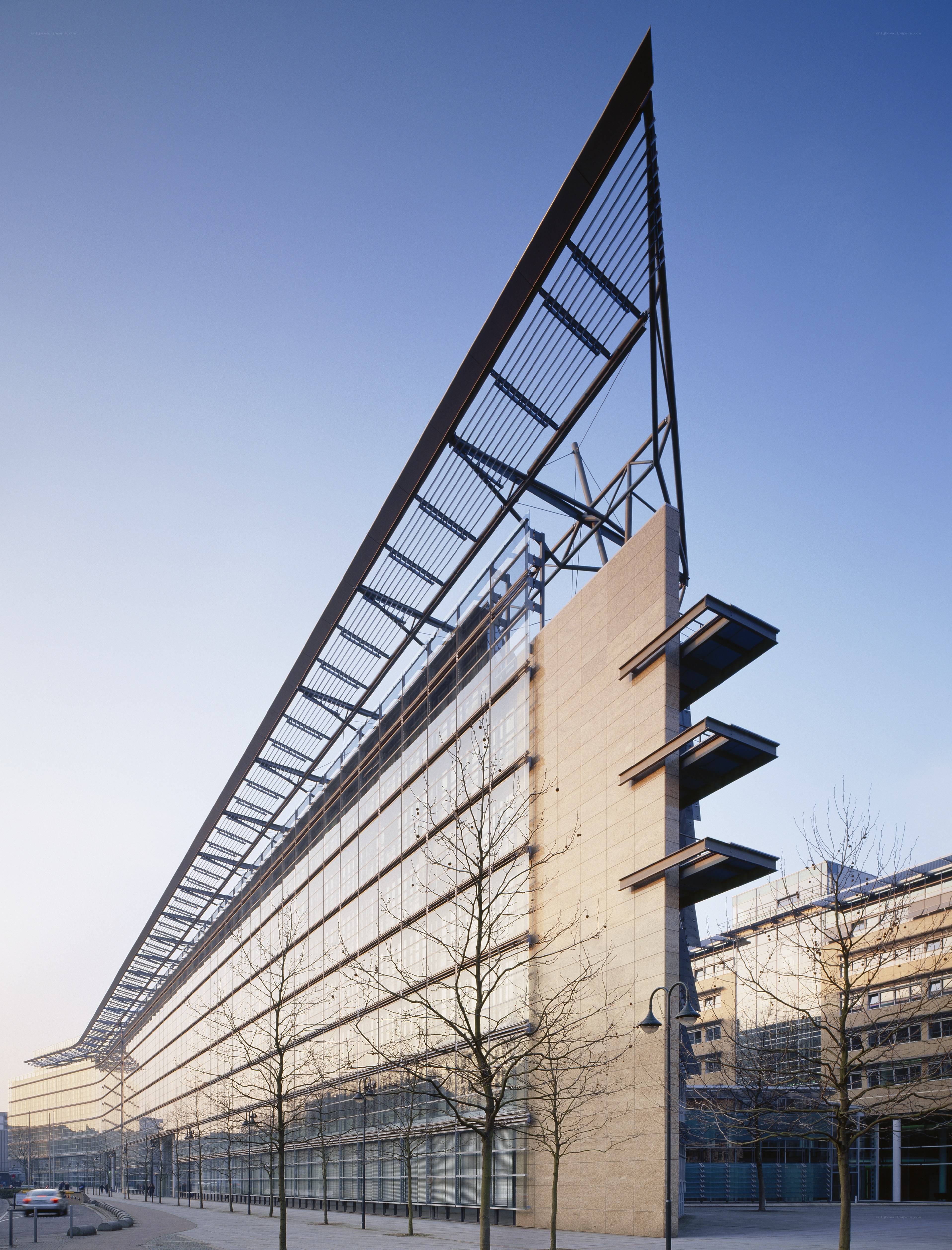 modern glass building with angled roof