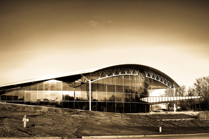 modern glass building with arched roof