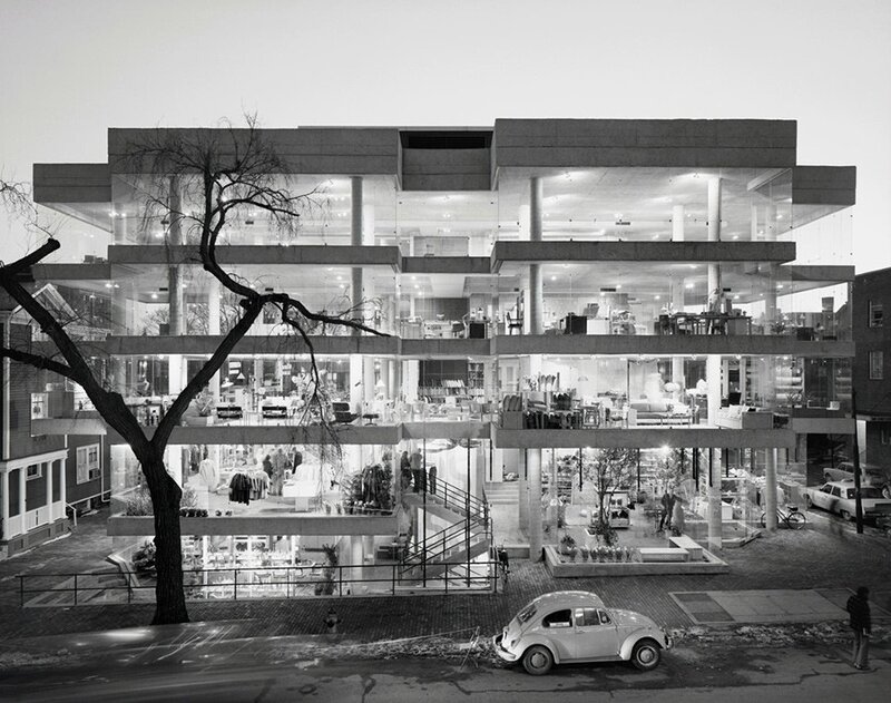 Modern glass building with cars