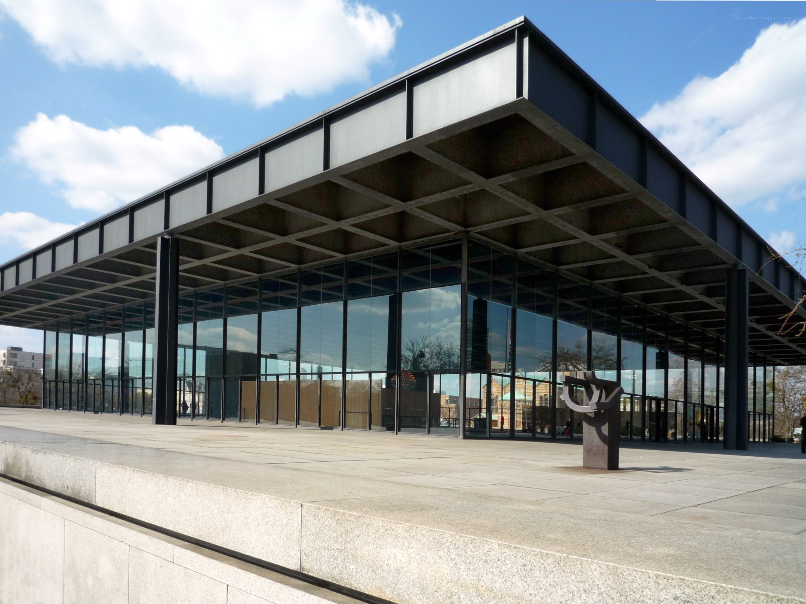 modern glass building with sculpture