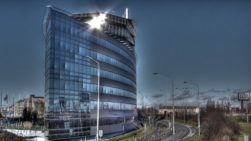 Modern glass building with sun glare
