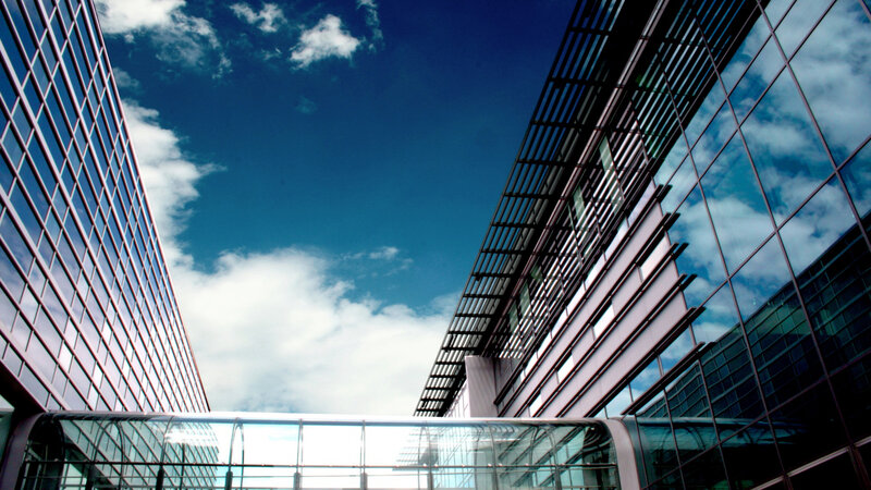 Modern glass buildings under blue sky