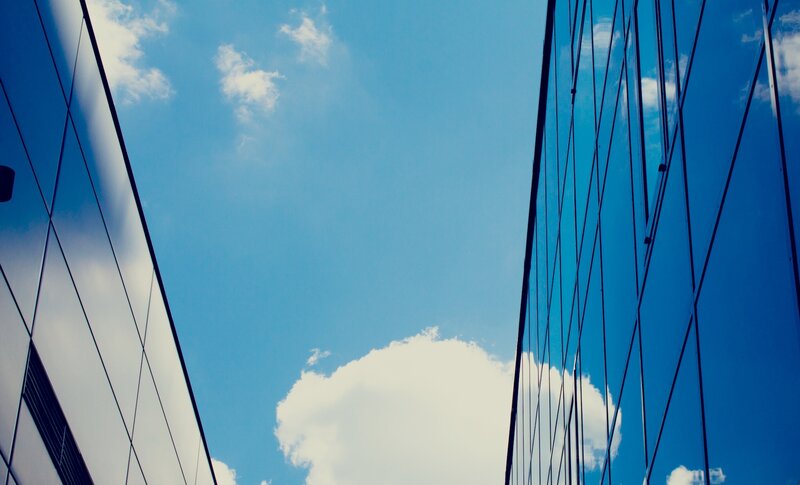 Modern glass buildings under blue sky