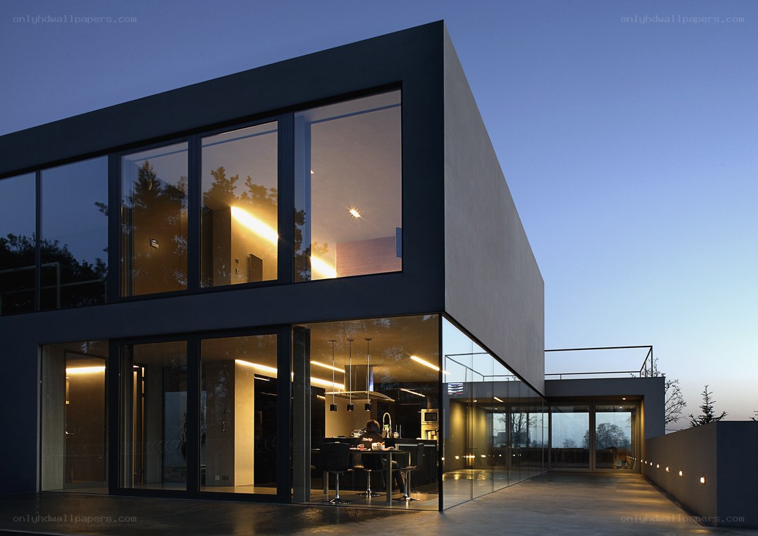 Modern glass house at dusk