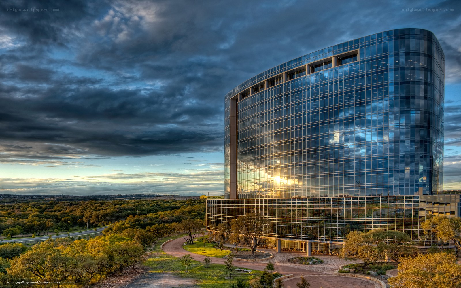 Modern glass skyscraper at sunset