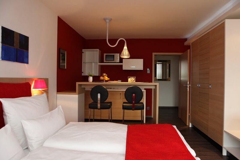 Modern hotel room with red accents
