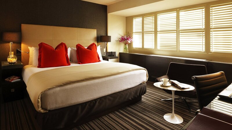 Modern hotel room with red pillows