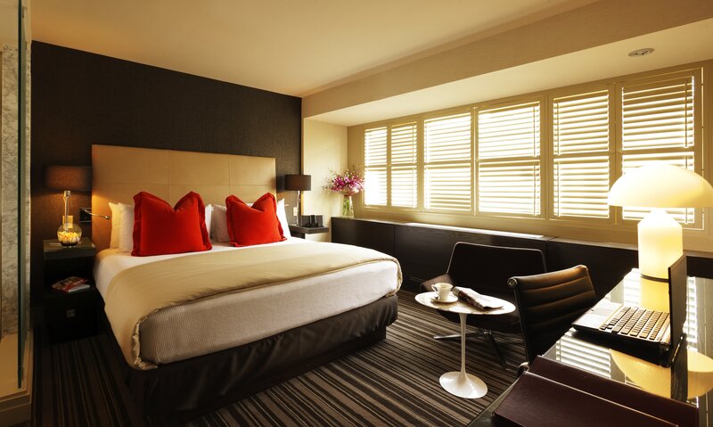 Modern hotel room with red pillows