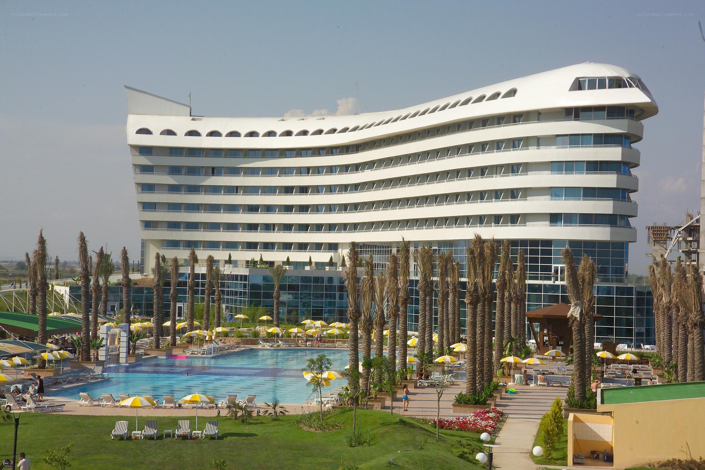 Modern hotel with pool and palm trees