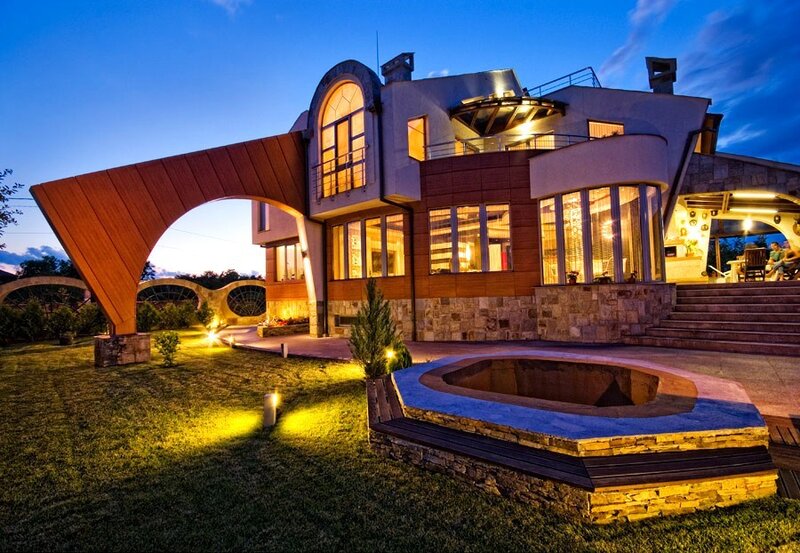 Modern house at dusk with outdoor seating
