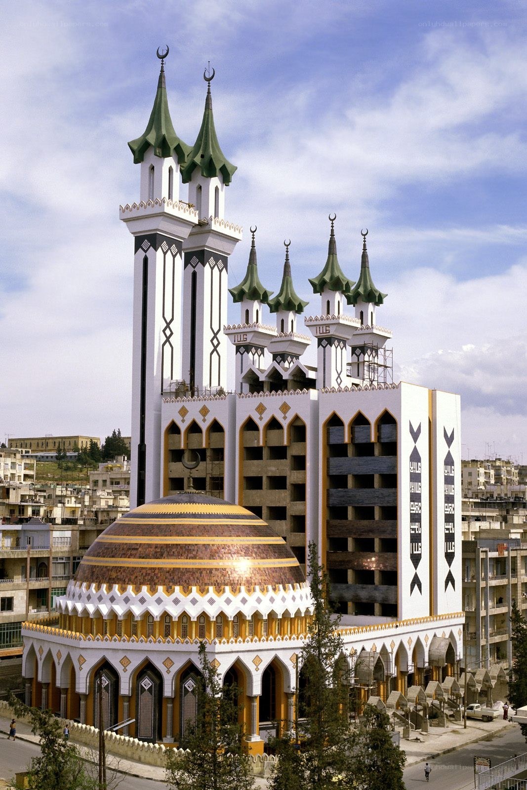 Modern mosque with green minarets