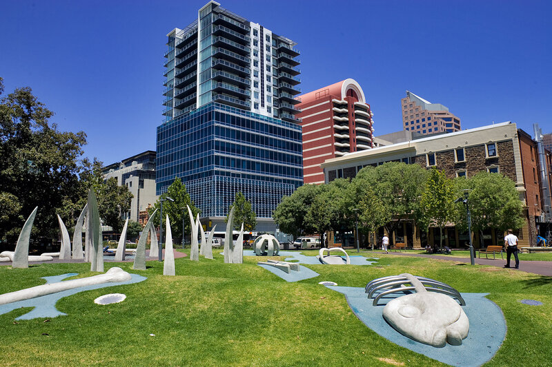Modern park with sculptures and skyscrapers