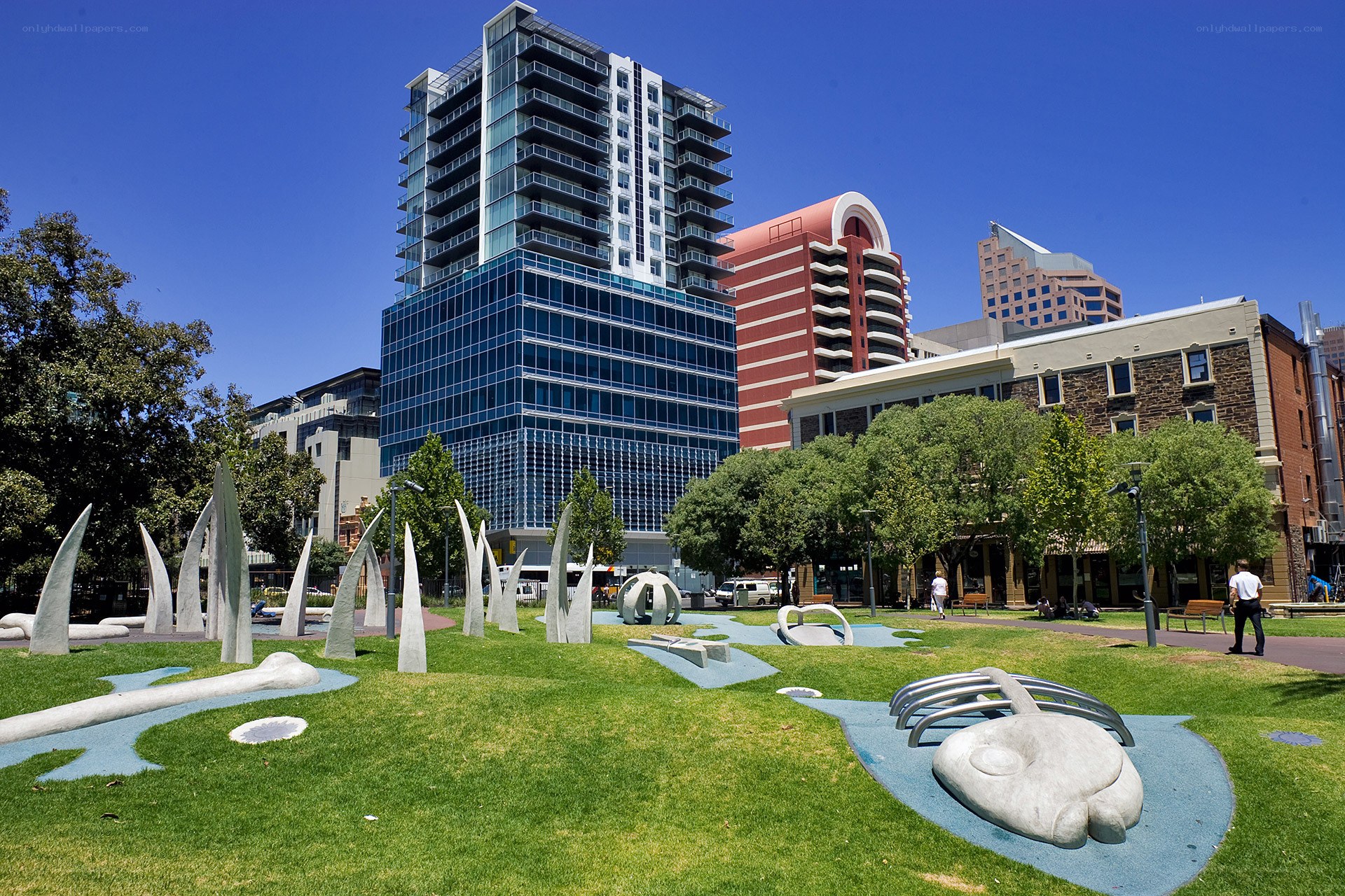 Modern park with sculptures and skyscrapers