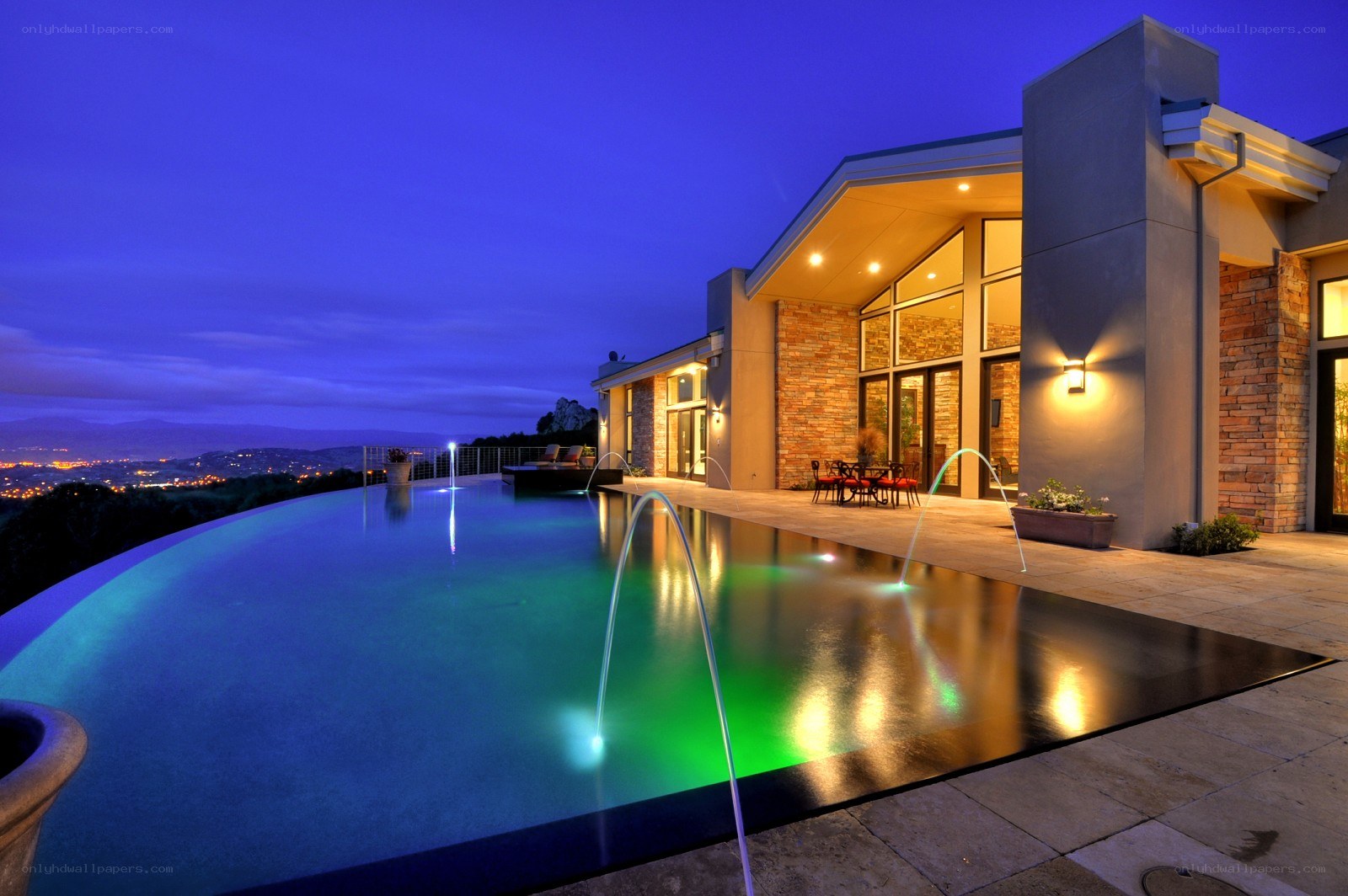 Modern pool at dusk with city view