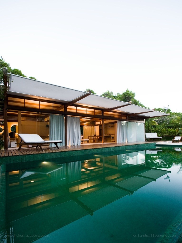 Modern poolside house with lounge chairs