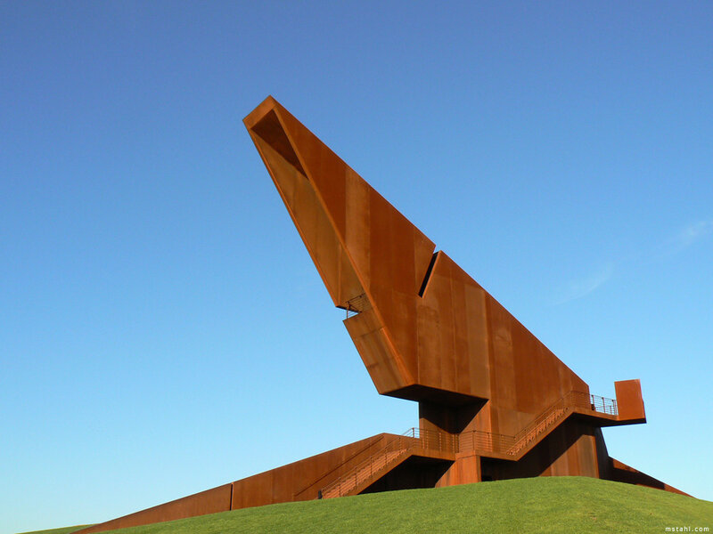 Modern sculpture on a grassy hill
