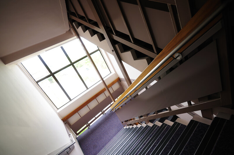 Modern staircase with wooden handrail